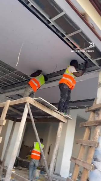 Workers installing an interior ceiling